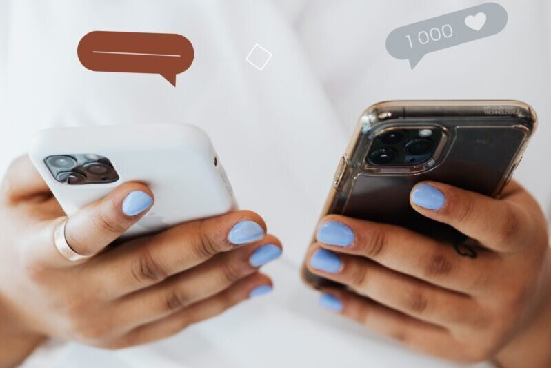 Close-up of person holding two smartphones, symbolizing modern communication trends.