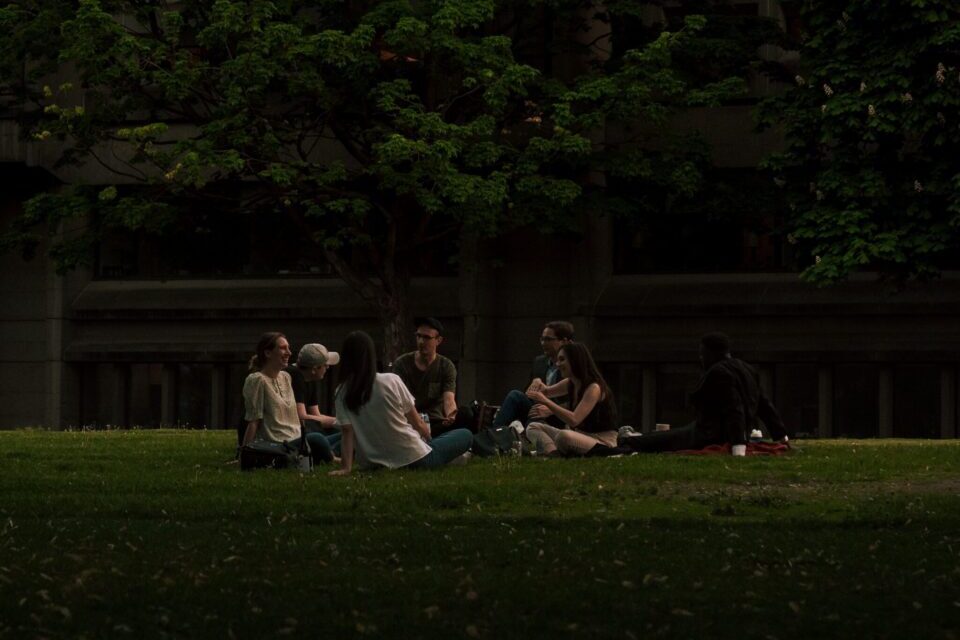 Group of friends sitting on bean bags in casual sneakers, enjoying a relaxed hangout.
